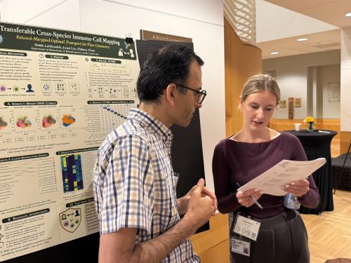 Sommer Holmes is talking with Habib Latifizadeh about his scientific poster.