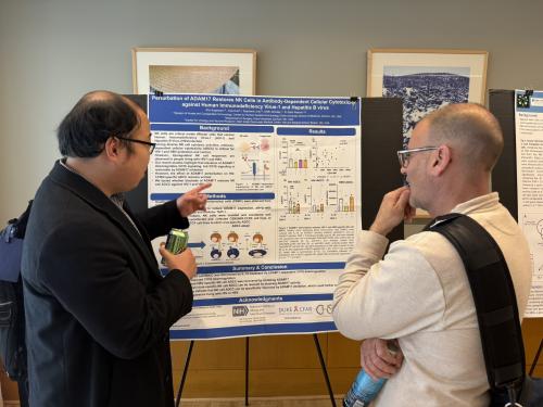 Sho Sugawara, PhD presents research to Justin Pollara, PhD.